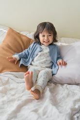 Toddler girl wearing Avauma Haze Heart cardigan over baby pajamas, soft and cozy baby outfit for bedtime